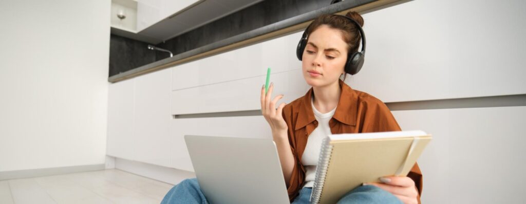 concentrated-young-student-woman-working-assignment-doing-homework-laptop-making-notes (2) (1)