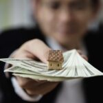business-man-show-money-bank-note-make-financial-plan-invite-people-sell-buy-house-car-monetary-properties-loan-credit-insurance-concept_1150-13575