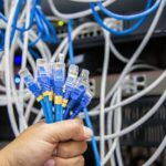 close-up-hand-choose-many-lan-network-cable_101448-2905
