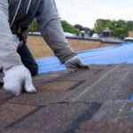 Roofers installing new roof on house