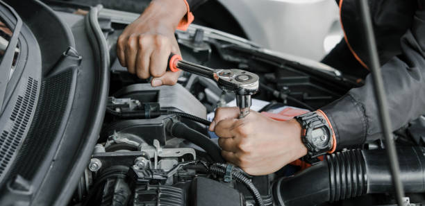 Mechanic fixing a car at home. Repair and service.