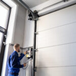 Garage Door Installation And Repair At Home. Contractor Man