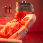 Blonde woman in Clinic undergoing Red LED light scalp treatment