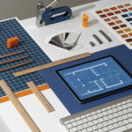 "Architect’s desk with digital CAD blueprint on tablet, rulers, pencils, and color samples."
