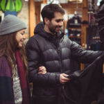 Couple selecting apparel together in a clothes shop