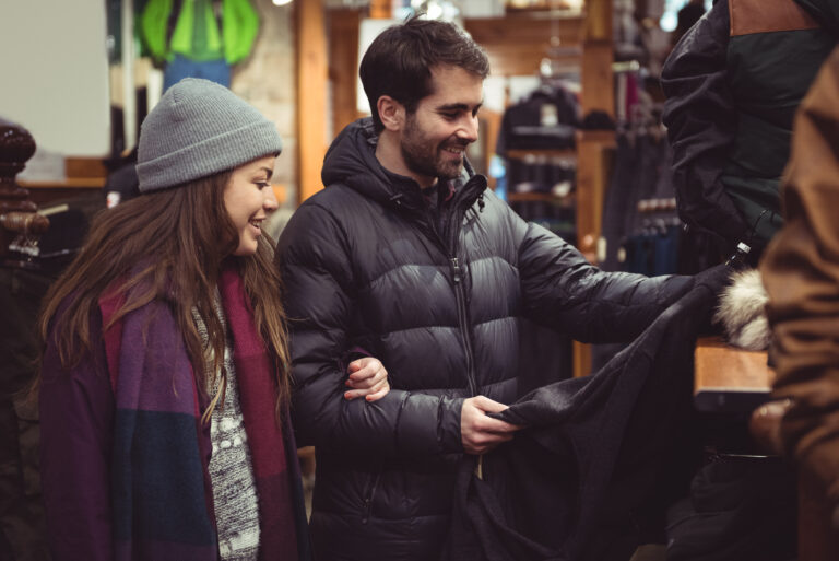 Couple selecting apparel together in a clothes shop