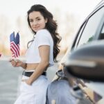 mid-shot-brunette-woman-holding-usa-flags-near-car
