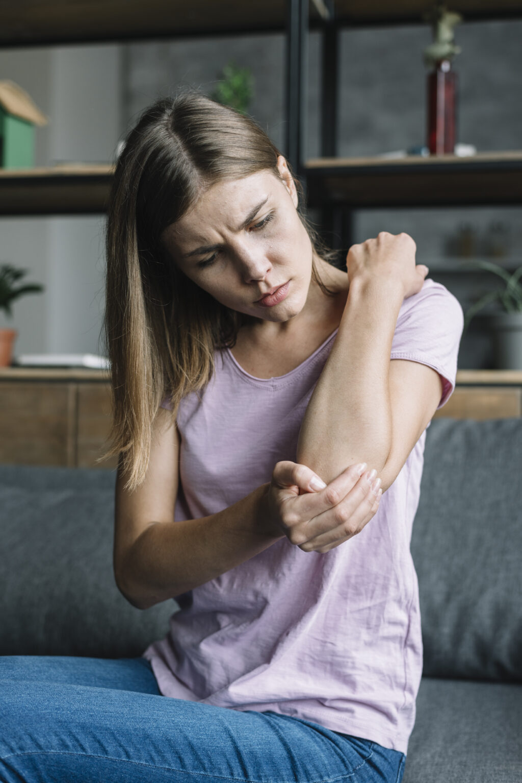 portrait-sick-young-woman-touching-her-elbow (1)