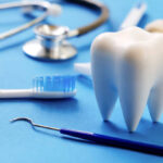 Dental model and dental equipment on blue background, Dentistry concept.