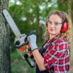 female-lumberjack-cutting-oak-tree-with-chainsaw-forest_342744-507