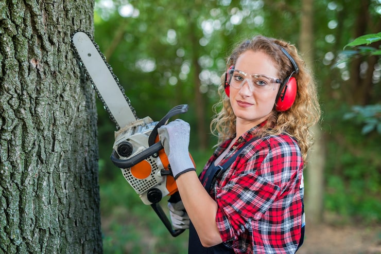 female-lumberjack-cutting-oak-tree-with-chainsaw-forest_342744-507