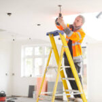 electrician installing downlights
