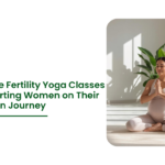 Pregnant woman practicing meditation pose at home representing Online Fertility Yoga Classes supporting conception and reproductive wellness