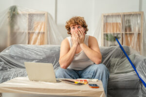 Man feeling stress and anxiety during home renovation