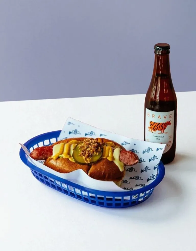 Custom food basket liners with branded grease-resistant paper sheets designed for serving burgers, fries, sandwiches, and other takeaway foods in restaurant baskets.