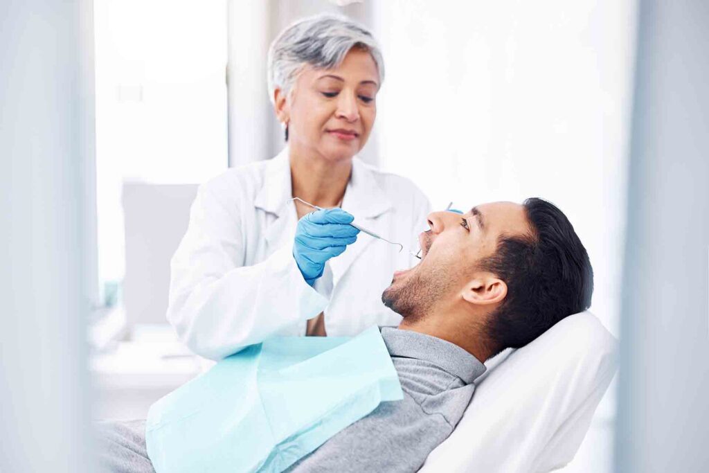 Woman,,Dentist,And,Check,Teeth,Of,Man,With,Tools,For