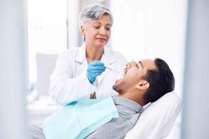Woman,,Dentist,And,Check,Teeth,Of,Man,With,Tools,For