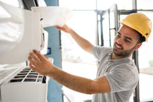 Technician cleaning air conditioner filter