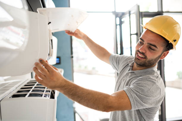 Technician cleaning air conditioner filter