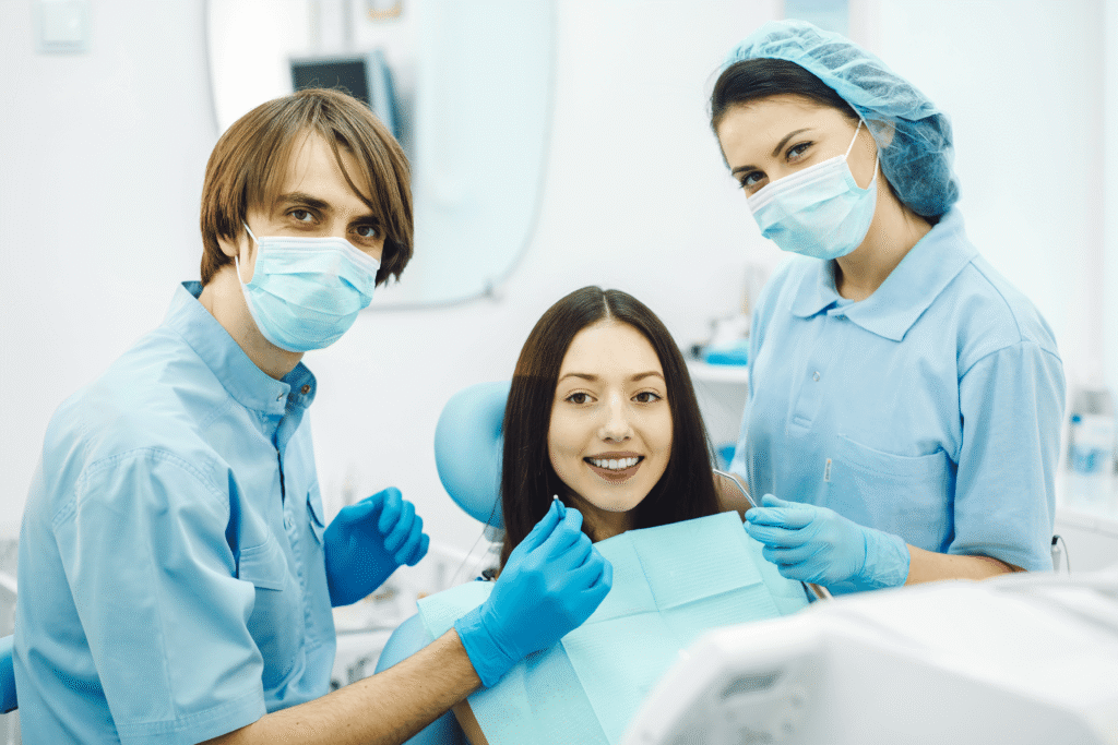 smiling-dentists-before-checking-patient (1)