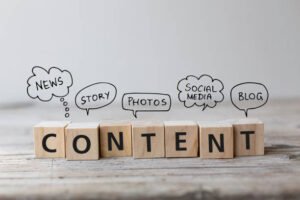 Wooden blocks spelling CONTENT with speech bubbles illustrating key content marketing strategies like news, stories, photos, social media, and blogs.
