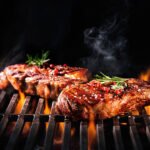 Beef steaks on the grill with flames