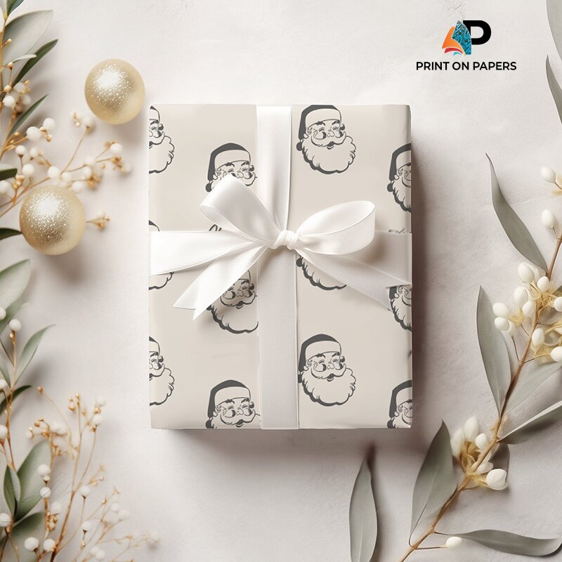 Elegant custom Christmas wrapping paper featuring black and white Santa Claus designs, finished with a white ribbon and bow.